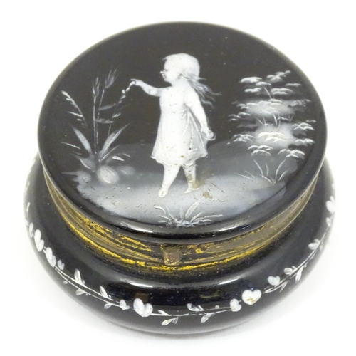 214 - A small black glass pot wit hinged lid having Mary Gregory detail to top. 2