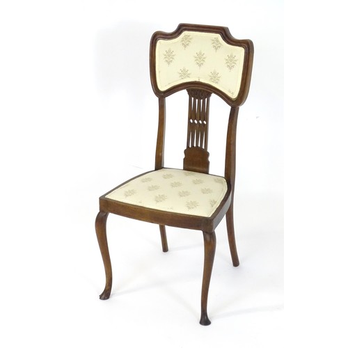 8 - An Edwardian mahogany Nouveau style side chair, having an upholstered backrest and seat with a pierc... 