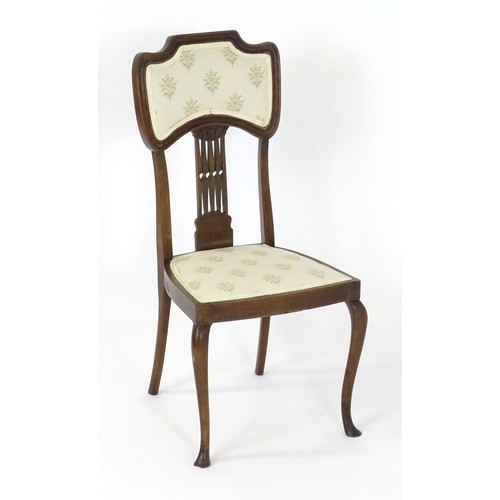 8 - An Edwardian mahogany Nouveau style side chair, having an upholstered backrest and seat with a pierc... 