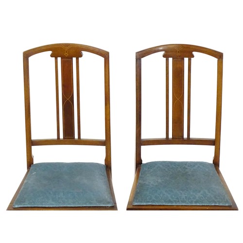 12 - A pair of Edwardian mahogany side chairs with satinwood inlaid stringing, the chairs raised on taper... 