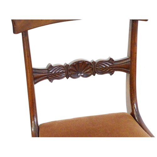 15 - A pair of 19hC mahogany side chairs, with bowed top rails, carved mid rails, drop in seats and raise... 