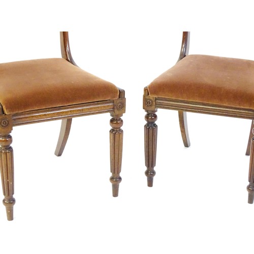 15 - A pair of 19hC mahogany side chairs, with bowed top rails, carved mid rails, drop in seats and raise... 