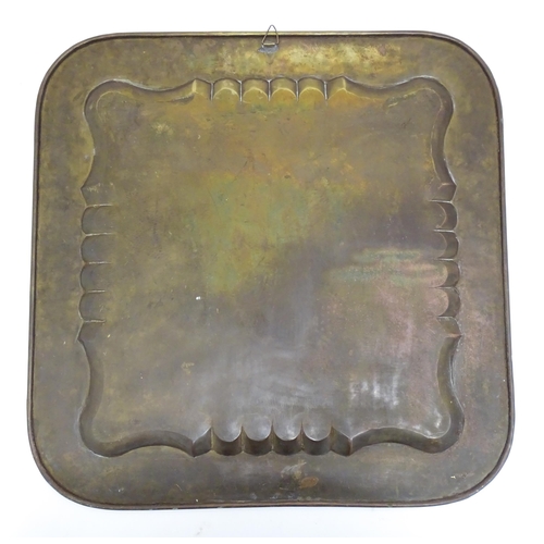 21 - A Persian brass tray of squared form with engraved decoration depicting a garden landscape with a ki... 