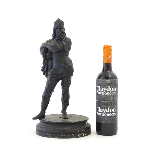 34 - A 20thC spelter sculpture modelled as a medieval king. Raised on a turned wooden base. Approx. 15 3/... 