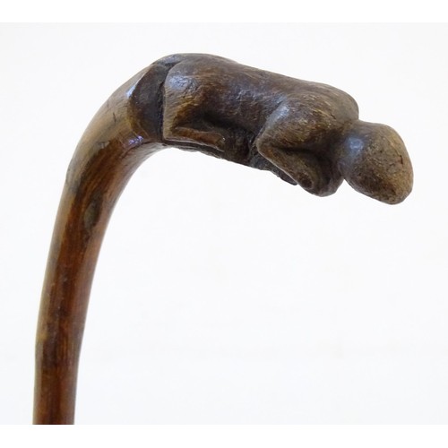 36 - An early 20thC tempered holly walking stick, together with a bamboo / cane walking stick with figura... 