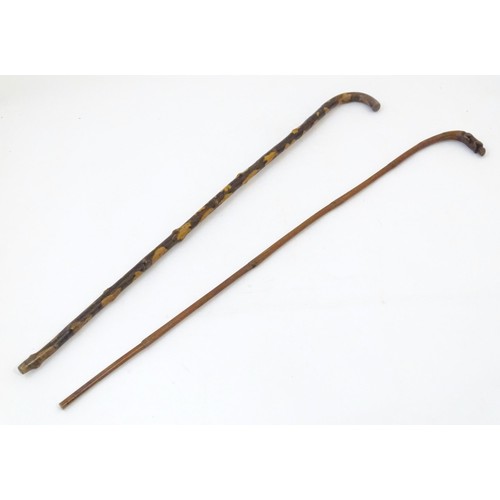 36 - An early 20thC tempered holly walking stick, together with a bamboo / cane walking stick with figura... 
