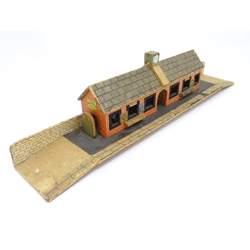 62 - Toys: A 20thC scratch built wooden model railway station / platform with various adverts for Shell, ... 