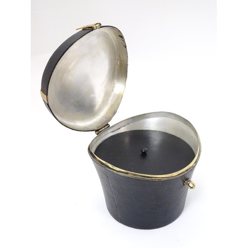 65 - A 21stC novelty brass caddy / container formed as a saddle shaped hat box with black leather coverin... 