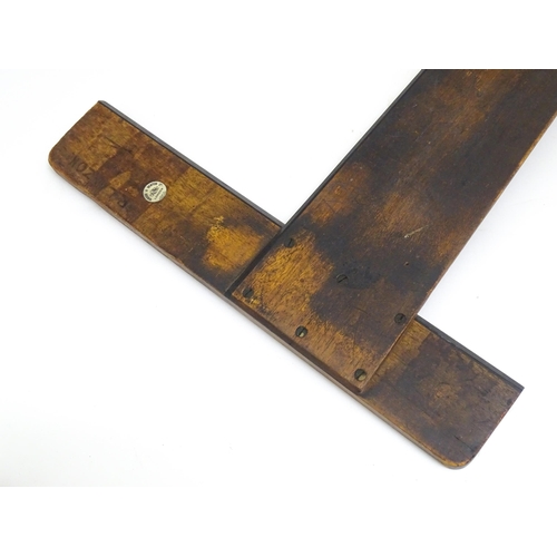 106 - Two artist's tools comprising an early 20thC wooden T-square by Winsor & Newton Ltd., and a George R... 