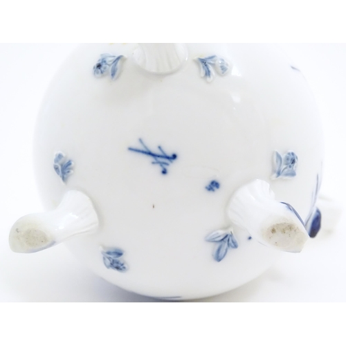 137 - A Swansea cow creamer. Together with a Continental blue and white three footed jug decorated with fl... 