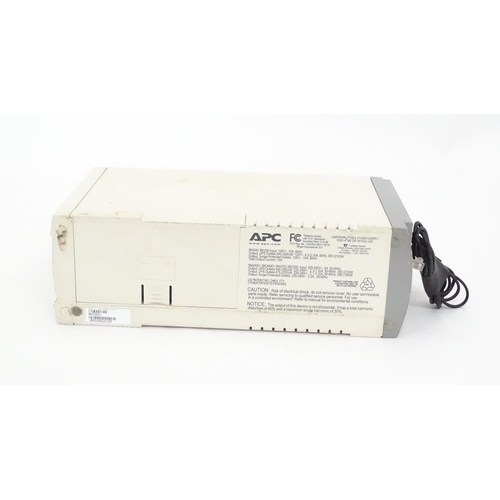 142 - An APC CS500 battery back up and surge protector, with instruction booklet. Approx 11