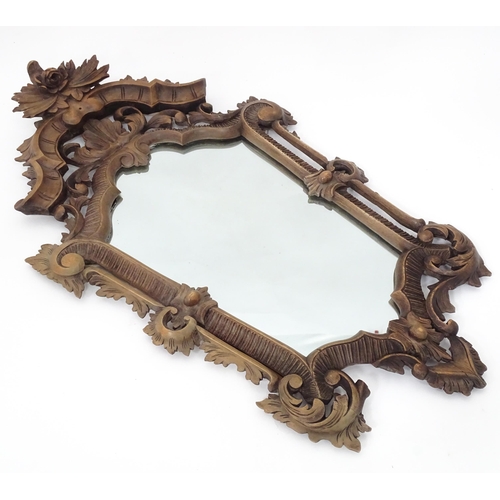 179 - A 20thC wall mirror with ornate frame, approx 22 1/2