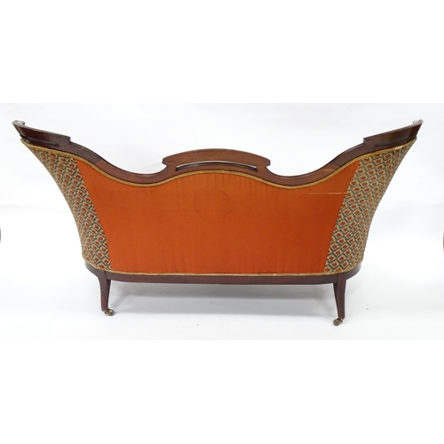 3 - A late 19thC / early 20thC sofa with a pierced top rail, sprung seat, serpentine e seat rail and rai... 