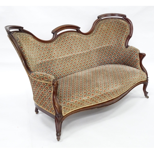 3 - A late 19thC / early 20thC sofa with a pierced top rail, sprung seat, serpentine e seat rail and rai... 