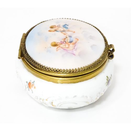 350 - A Continental ceramic pot and cover with mirror to interior, the hinged lid decorated with putti amo... 