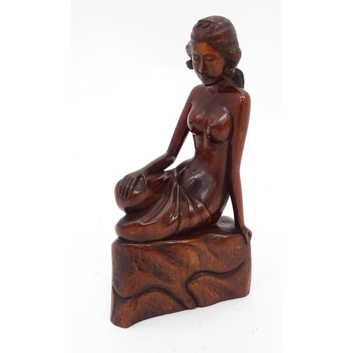 112 - A carved wooden model of a seated nude. Approx. 11 3/4