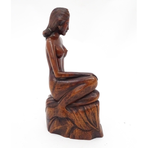 112 - A carved wooden model of a seated nude. Approx. 11 3/4