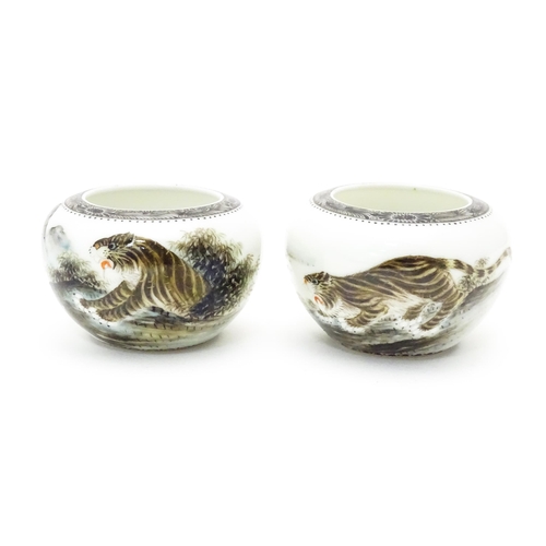 353 - A pair of Oriental ceramic salts with tiger decoration and Character script. Character marks under. ... 