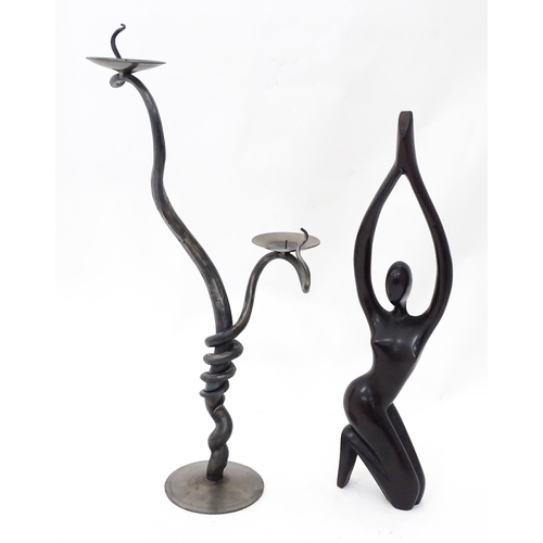 93 - A blacksmith-made wrought iron candelabra, together with a carved figure, the largest approx 26