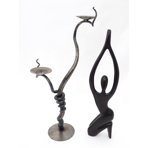 93 - A blacksmith-made wrought iron candelabra, together with a carved figure, the largest approx 26