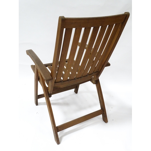 835 - Two teak garden chairs, with cushions