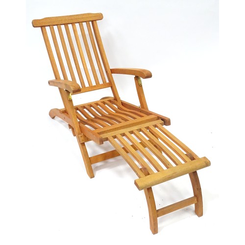 837 - A teak steamer style garden chair / lounger with cushion.