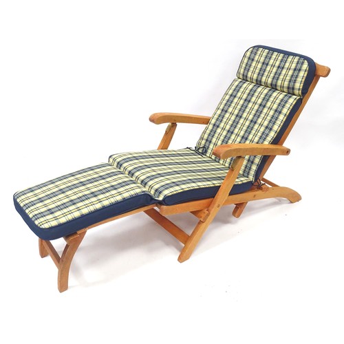 837 - A teak steamer style garden chair / lounger with cushion.