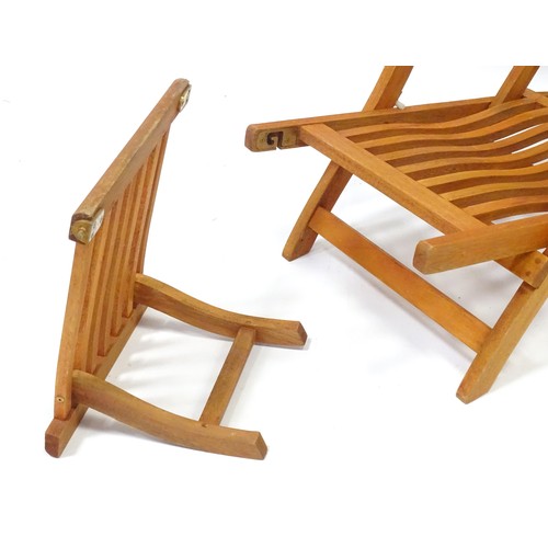 837 - A teak steamer style garden chair / lounger with cushion.