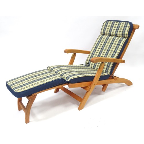 837 - A teak steamer style garden chair / lounger with cushion.