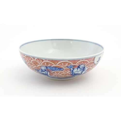 39 - A Chinese blue, white and pink bowl the exterior decorated with the Eight Immortals upon their attri... 