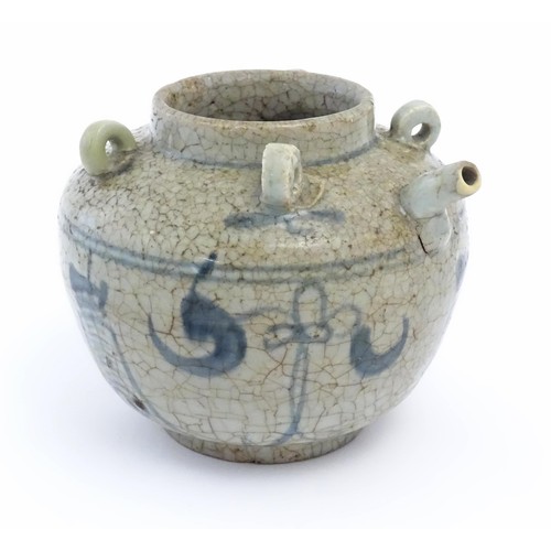 41 - An Oriental stoneware water pot / jar with four loop handles, a spout and crackle glaze with blue br... 