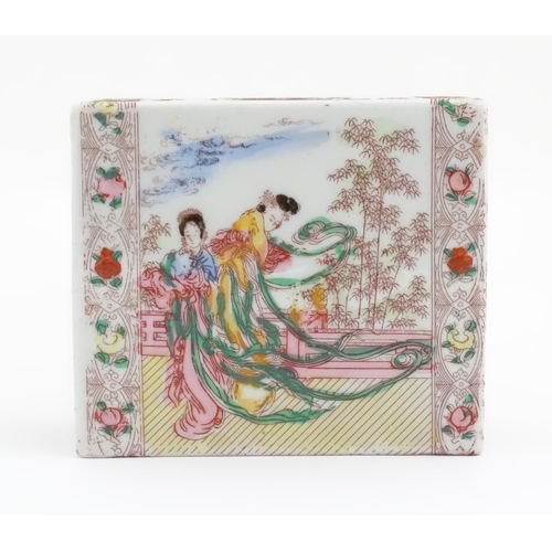 57 - A Chinese pillow / flower brick decorated with female figures in a garden terrace, bordered by flowe... 