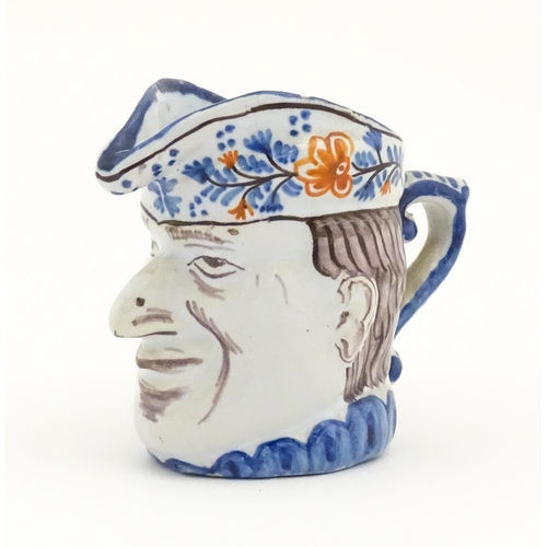 73 - A French faience character / Toby jug, possibly modelled as Mr Punch. Approx. 3 1/4