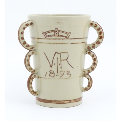 81 - A beaker / tyg  with three loop handles, the body with hand painted decoration depicting a lion ramp... 