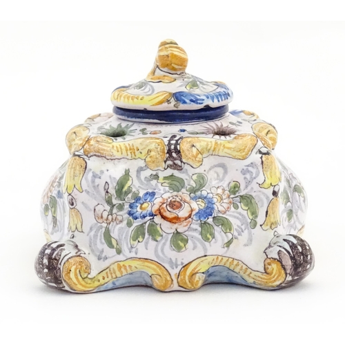 85 - A Continental faience inkwell of shaped form with hand painted floral and foliate decoration. Approx... 