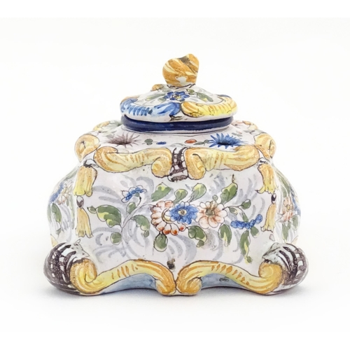 85 - A Continental faience inkwell of shaped form with hand painted floral and foliate decoration. Approx... 