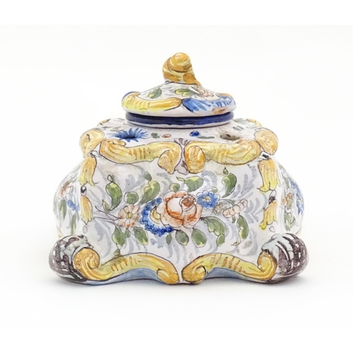 85 - A Continental faience inkwell of shaped form with hand painted floral and foliate decoration. Approx... 