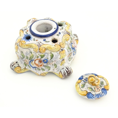 85 - A Continental faience inkwell of shaped form with hand painted floral and foliate decoration. Approx... 