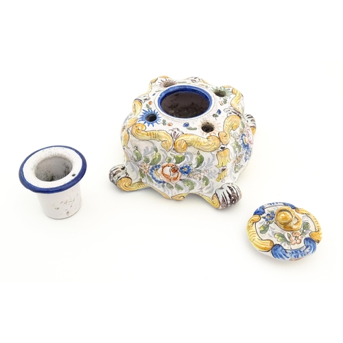 85 - A Continental faience inkwell of shaped form with hand painted floral and foliate decoration. Approx... 