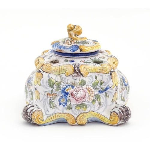 85 - A Continental faience inkwell of shaped form with hand painted floral and foliate decoration. Approx... 