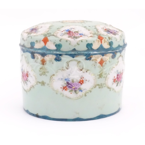 89 - A Continental pot and cover decorated with hand painted floral vignettes. Approx. 4