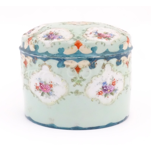 89 - A Continental pot and cover decorated with hand painted floral vignettes. Approx. 4