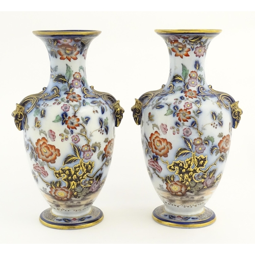 160 - A pair of Oriental baluster vases with twin stylised animal mask handles, decorated in the Imari pal... 