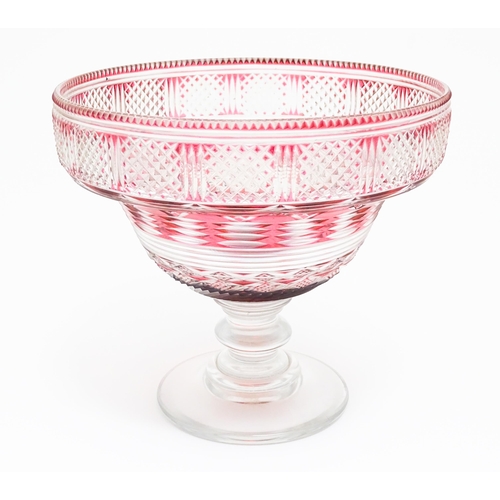 196 - A 19thC cut glass /  crystal pedestal bowl with cranberry flash detail. Approx 9 1/2