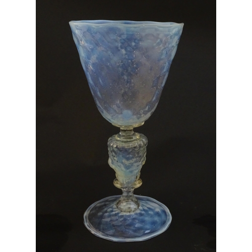 202 - A Venetian glass goblet / pedestal drinking glass with vaseline detail. Approx 6 3/4