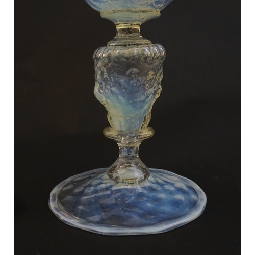 202 - A Venetian glass goblet / pedestal drinking glass with vaseline detail. Approx 6 3/4