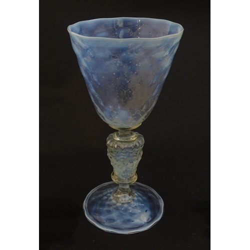 202 - A Venetian glass goblet / pedestal drinking glass with vaseline detail. Approx 6 3/4