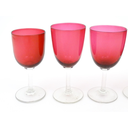 203 - Six assorted cranberry glass drinking glasses, with cranberry coloured bowls and clear glass stem an... 