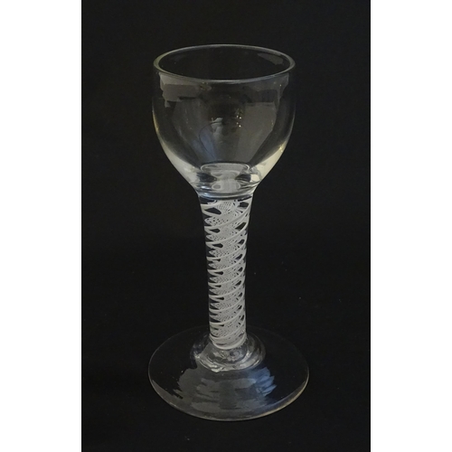 229 - A 19thC pedestal drinking glass with twist detail to stem. Approx 5