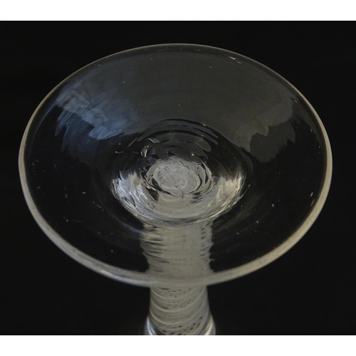 229 - A 19thC pedestal drinking glass with twist detail to stem. Approx 5